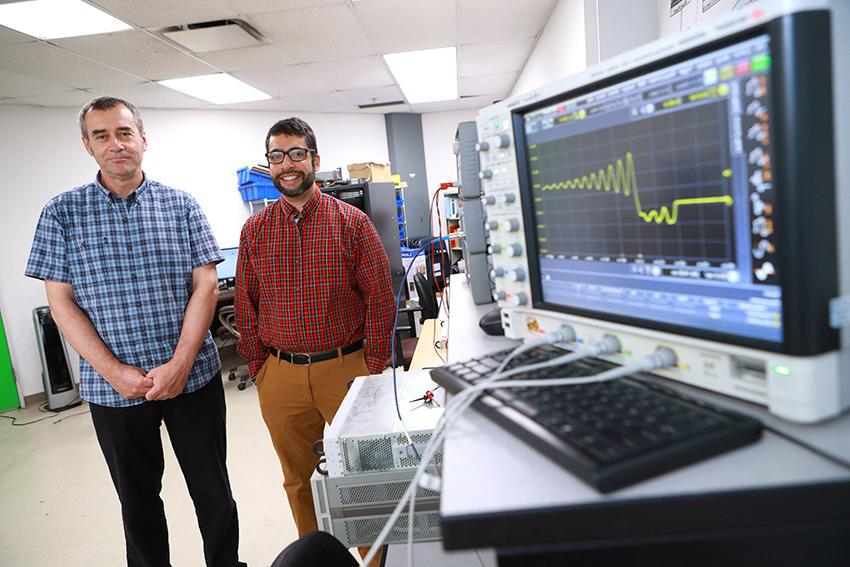 丹尼尔·乔治耶夫博士.D.和Raghav Khanna博士.D.，站在实验室里. 附近的监视器显示出一个波形.